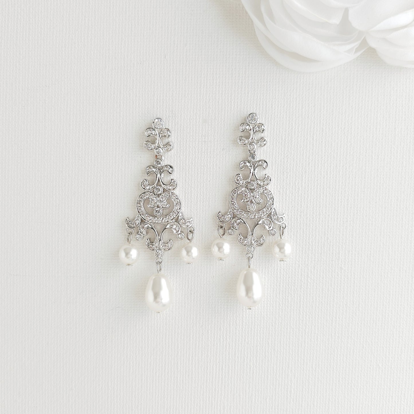Lightweight silver vintage style pearl drop chandelier earrings featuring cubic zirconia and flawless round crystal pearls.