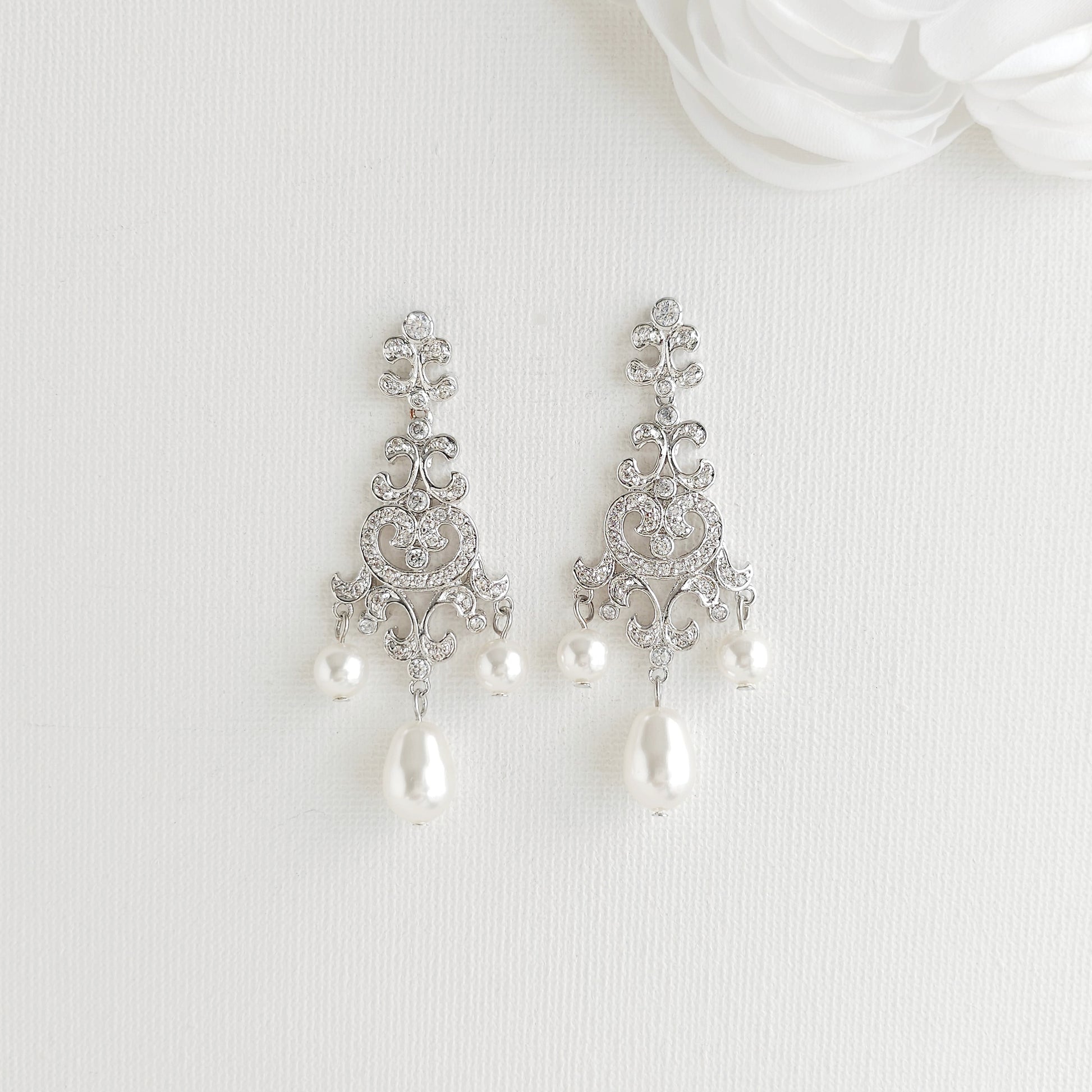Lightweight silver vintage style pearl drop chandelier earrings featuring cubic zirconia and flawless round crystal pearls.