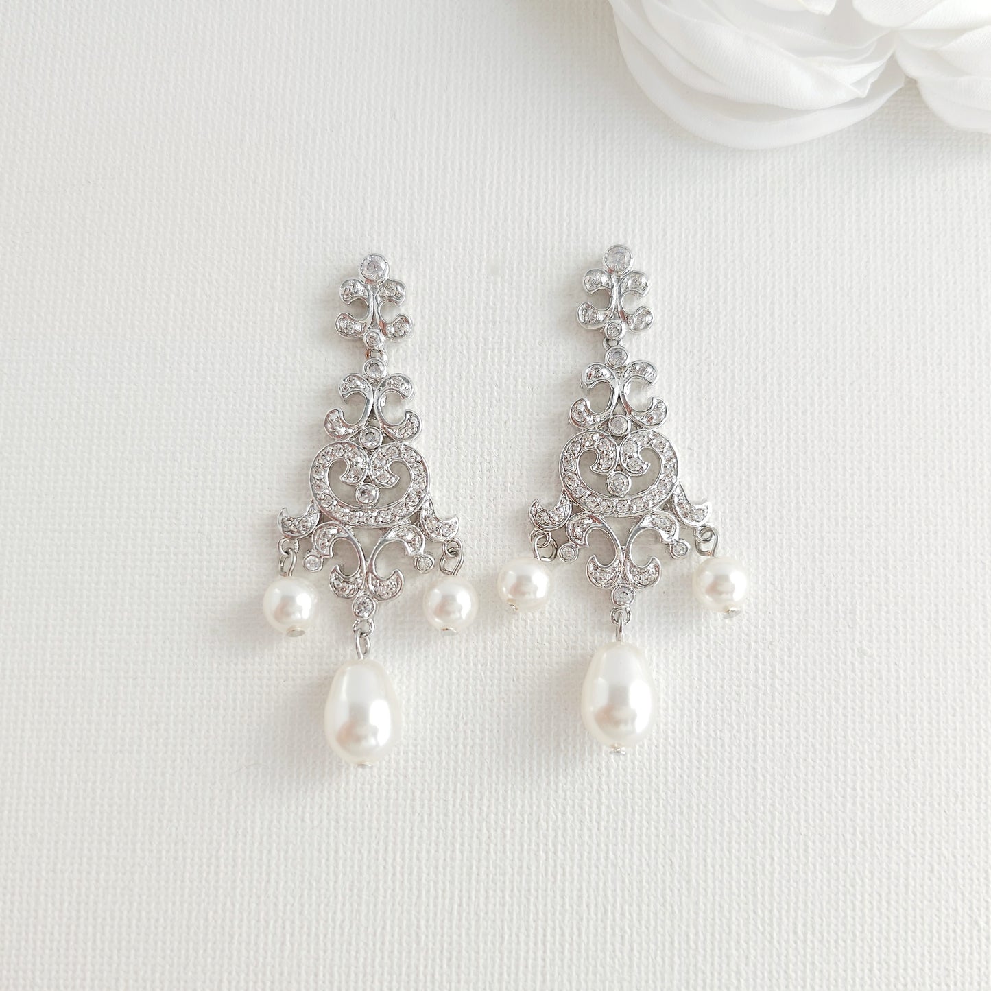Lightweight silver vintage style pearl drop chandelier earrings featuring cubic zirconia and flawless round crystal pearls.