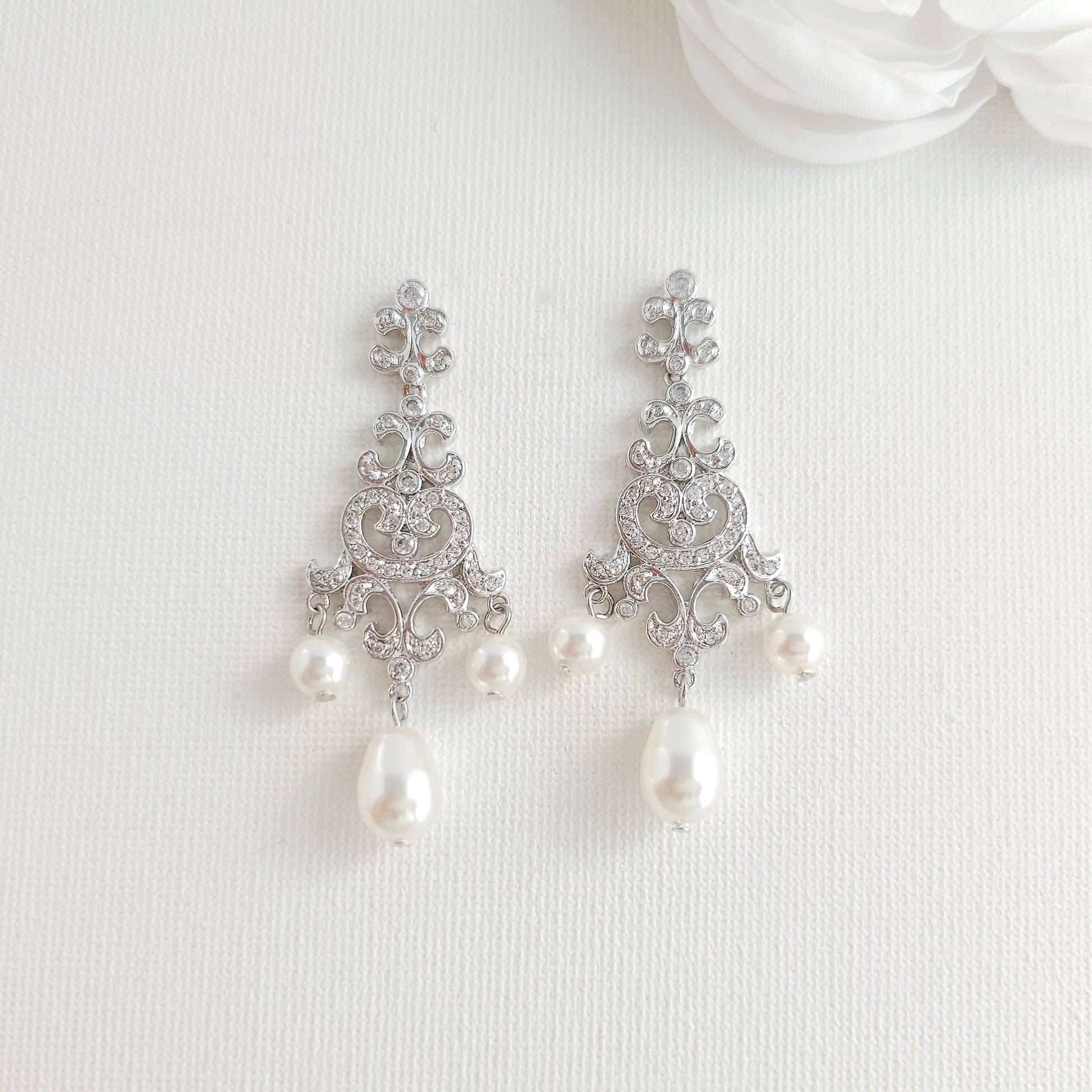 Lightweight silver vintage style pearl drop chandelier earrings featuring cubic zirconia and flawless round crystal pearls.