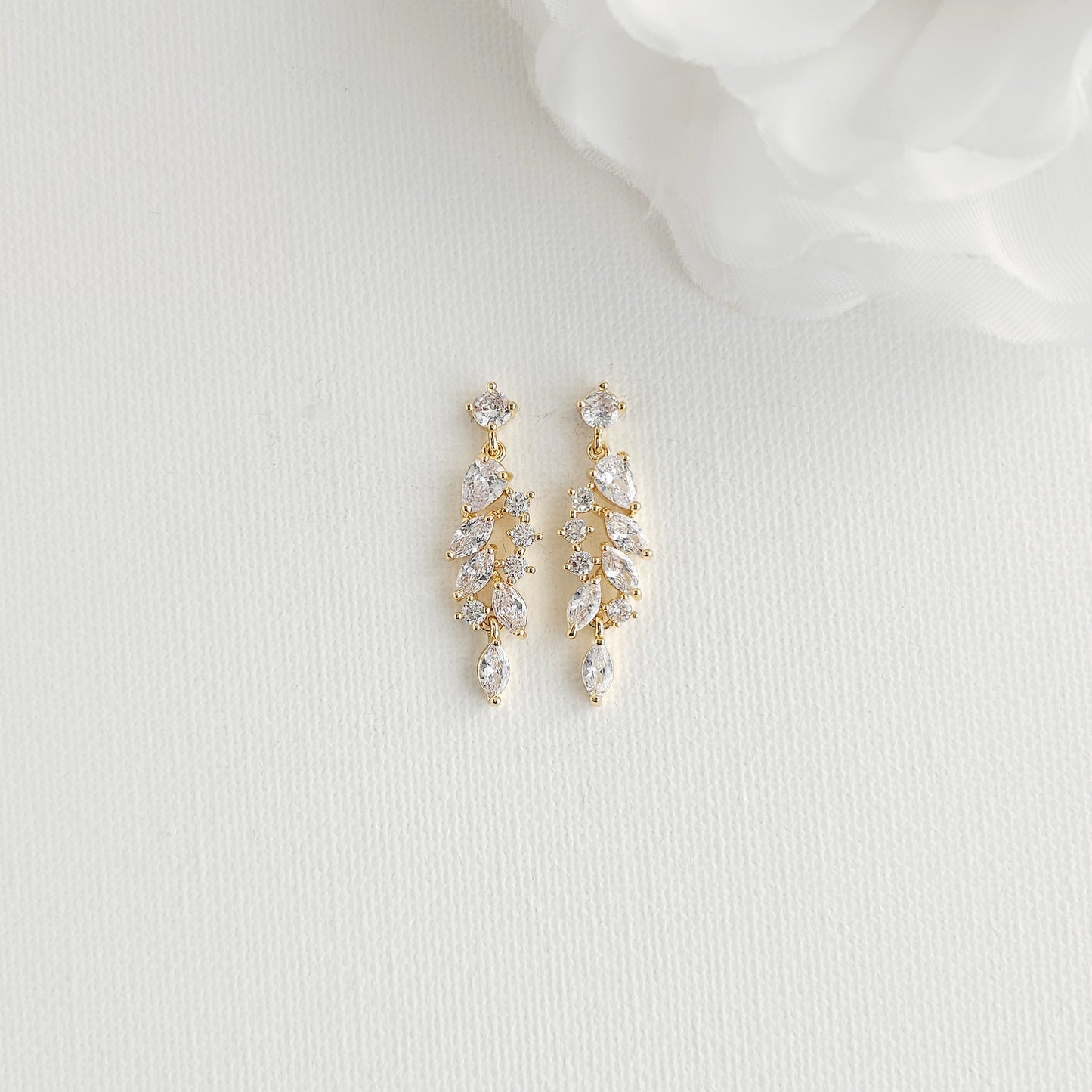 A pair of gold drop earrings with clear marquise and round-cut CZ 