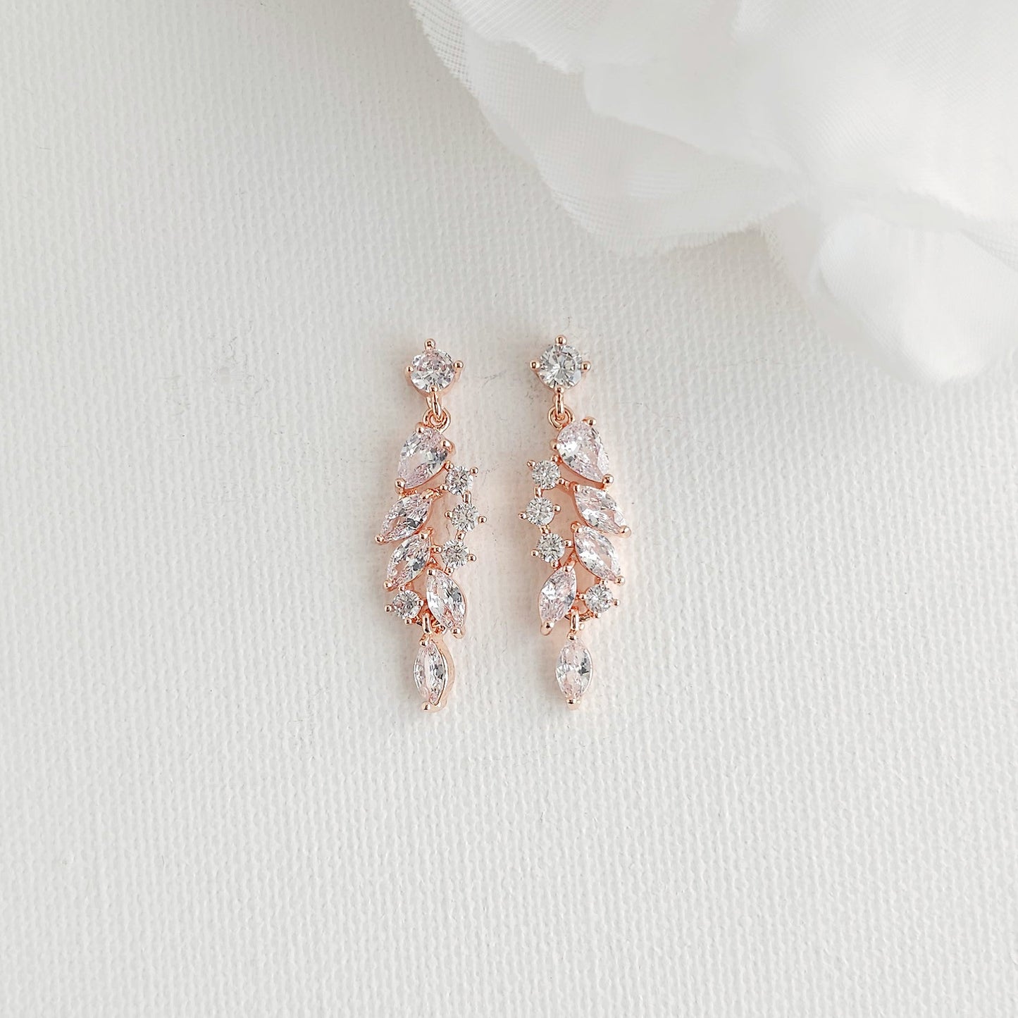 Delicate rose gold leaf drop earrings featuring an articulated marquise cubic zirconia cluster, perfect for blush, champagne, and ivory gowns.