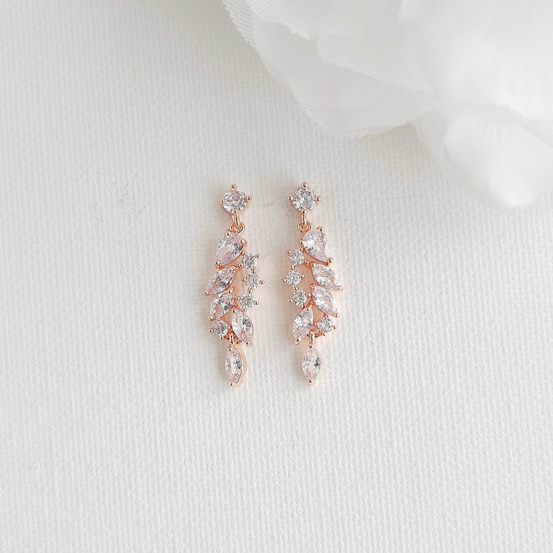 Delicate rose gold leaf drop earrings featuring an articulated marquise cubic zirconia cluster, perfect for blush, champagne, and ivory gowns.