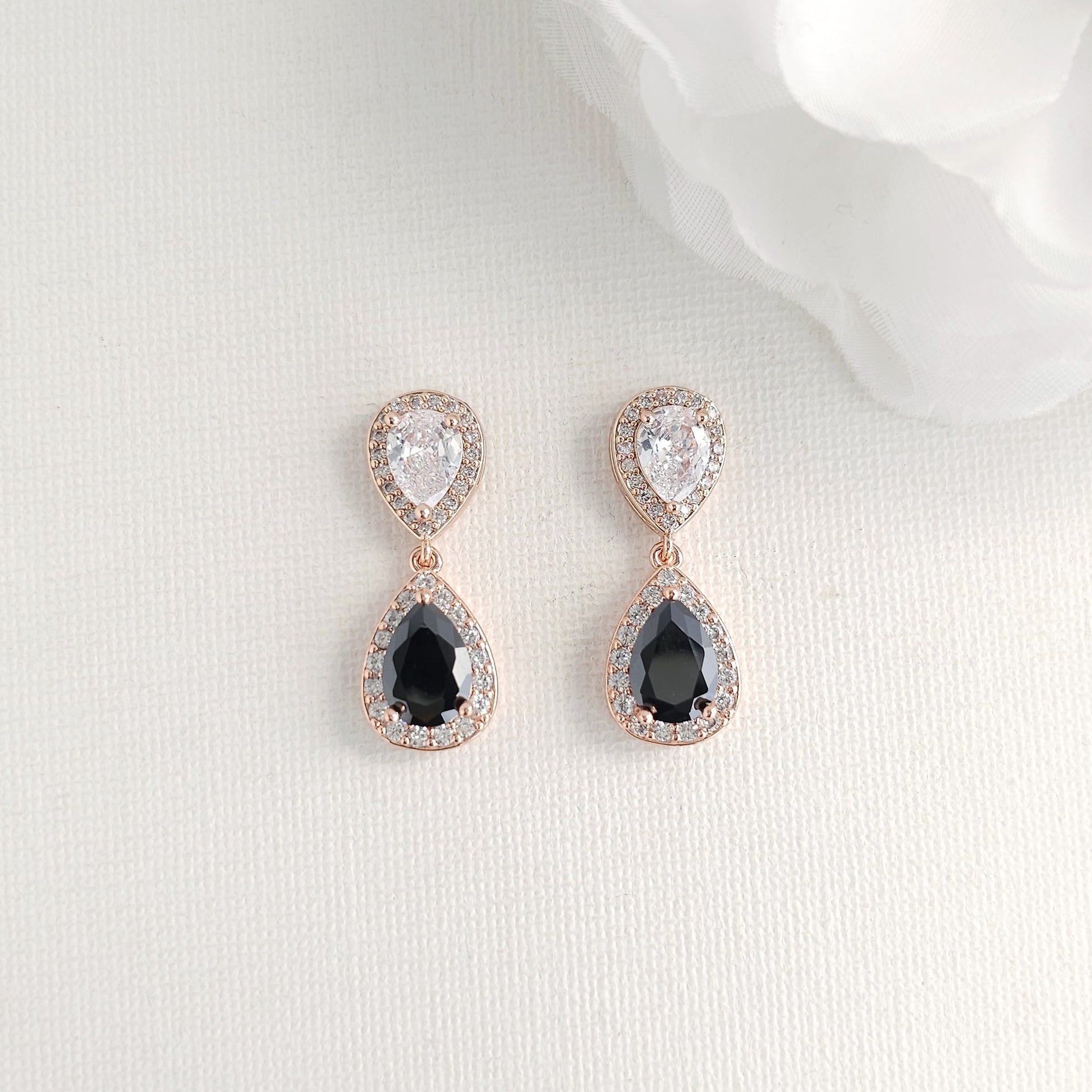 Teardrop-shaped earrings with black CZ stones on a white background