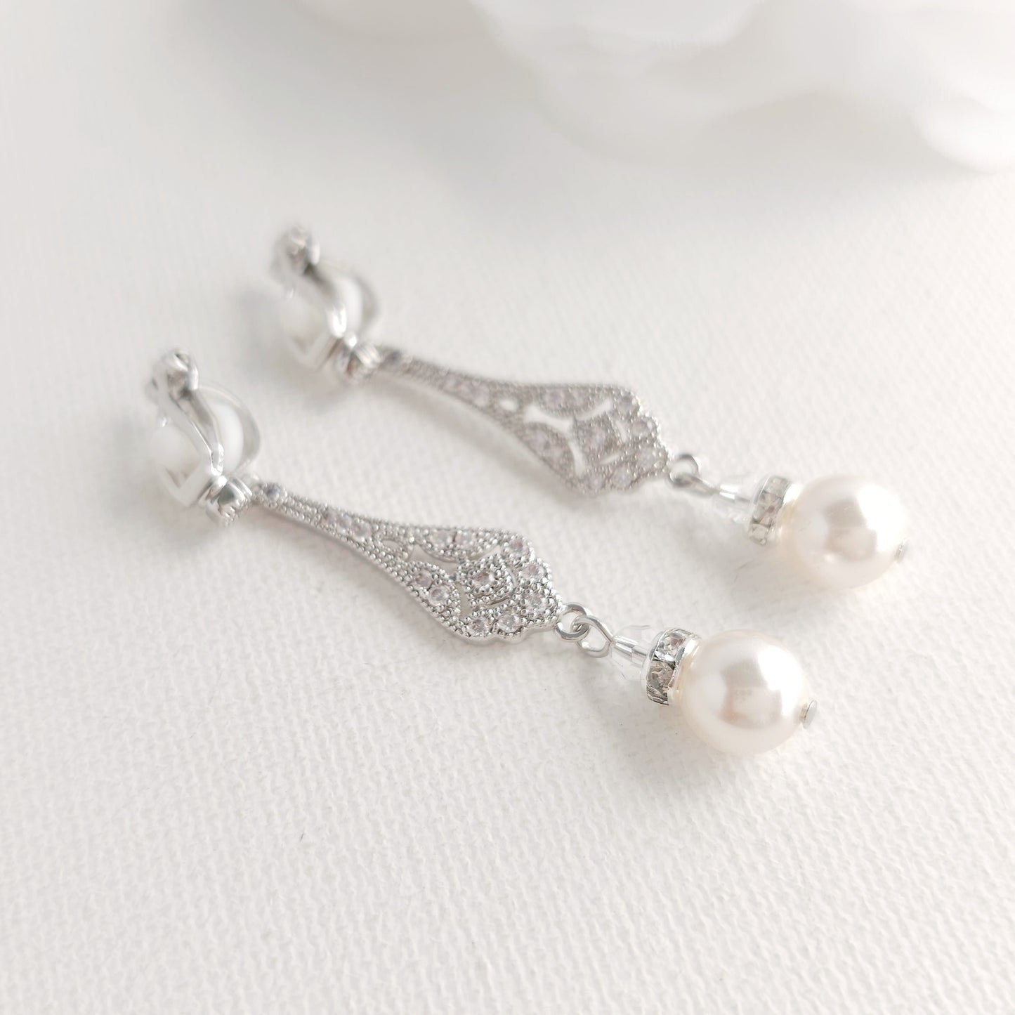 Silver earrings with pearl drops are comfortable and secure