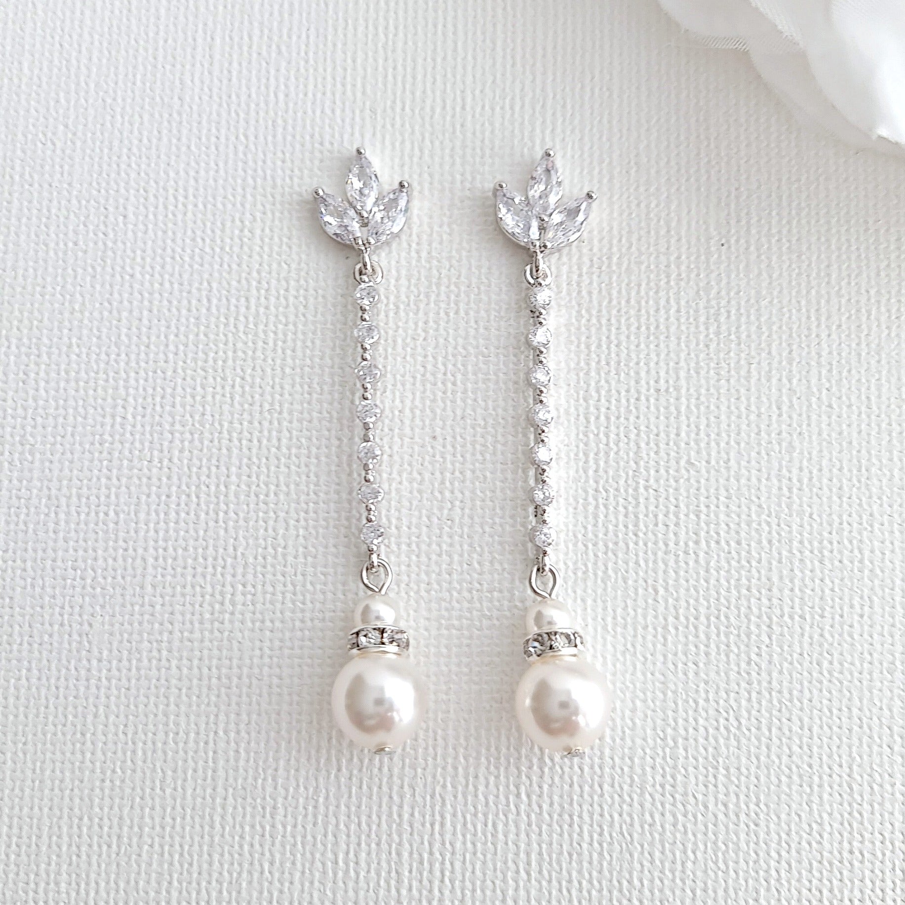 Long dangling pearl on sale earrings